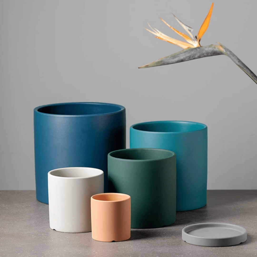 Handcrafted ceramic flowerpot with saucer, a chic addition to home decor.