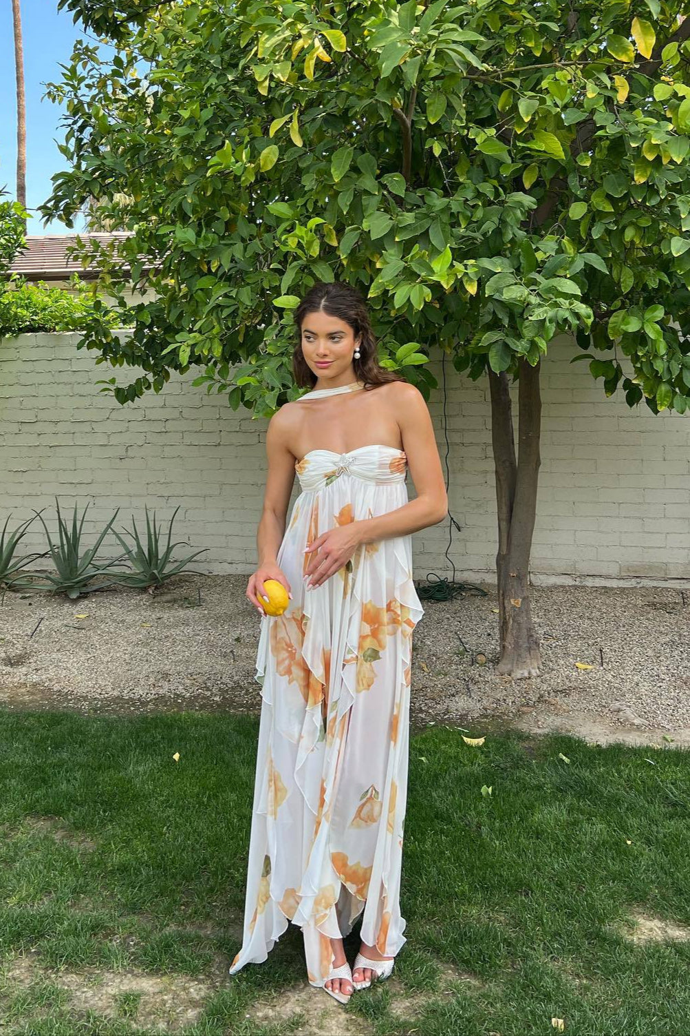 Elegant white halter maxi dress for women, perfect for summer vacations or beachwear, featuring a flowing silhouette.