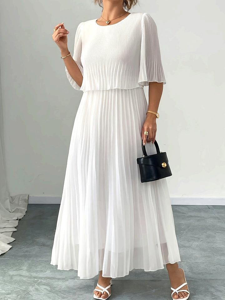 Elegant white pleated A-line maxi dress for women, perfect as a wedding guest or formal evening gown.