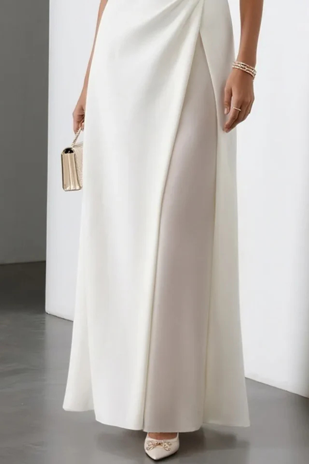 Graceful sleeveless white maxi dress for women, featuring an elegant side slit & draped waist, ideal for formal wear.
