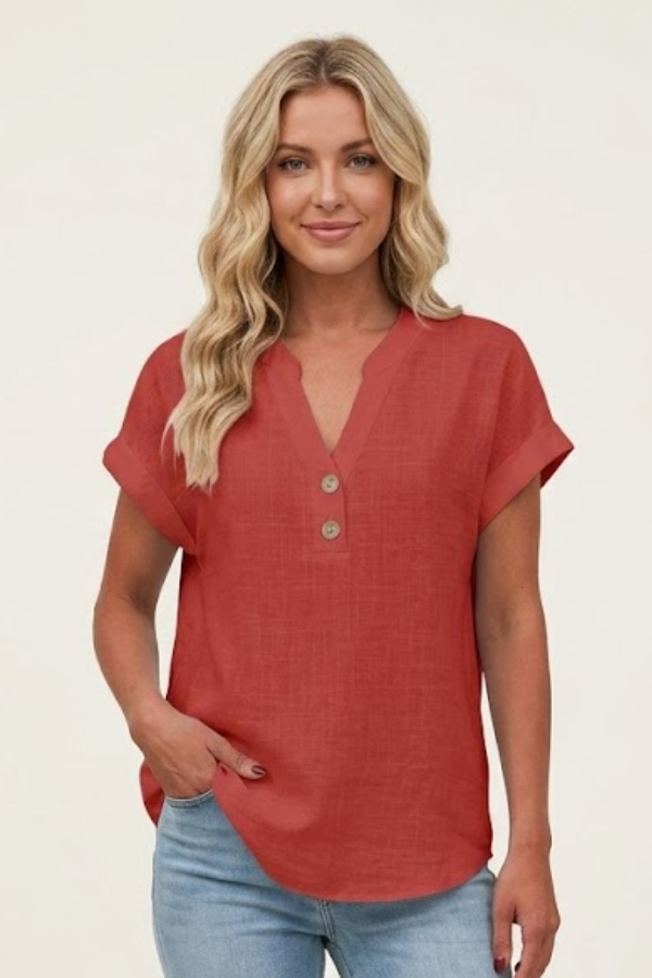 Close-up of buttons on an elegant V-neck short sleeve women's blouse, highlighting versatile office & casual top.