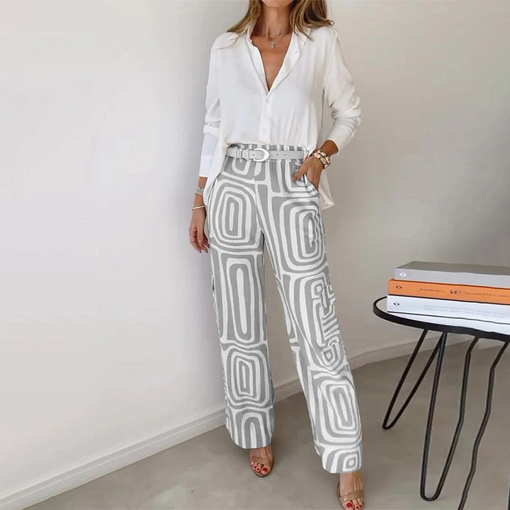 Versatile women's two-piece outfit: elegant flowing top & fashionable patterned trousers for any chic occasion.