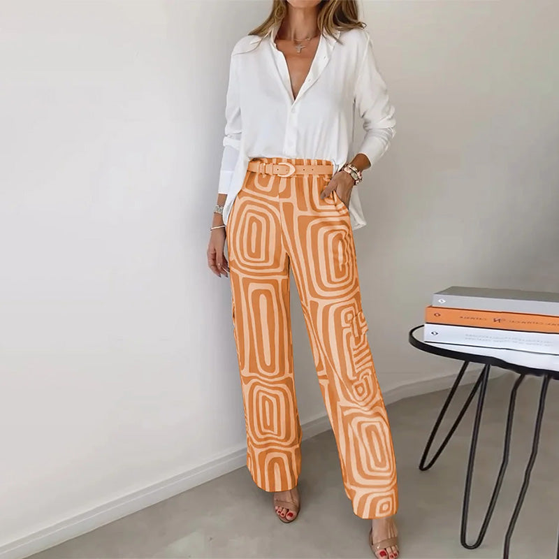 Chic women's 2-piece set: loose flowing top & stylish patterned trousers. Modern elegant ensemble.