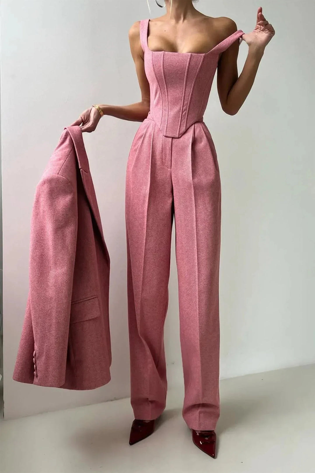 Pink women's formal wear three-piece set with a flattering corset bustier, wide leg pants & chic blazer.