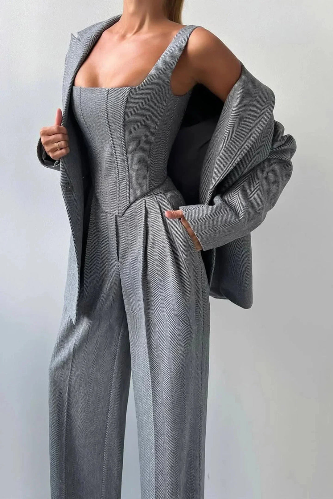 Elegant gray women's co-ord set for business or formal events, with bustier, wide leg pants & blazer.