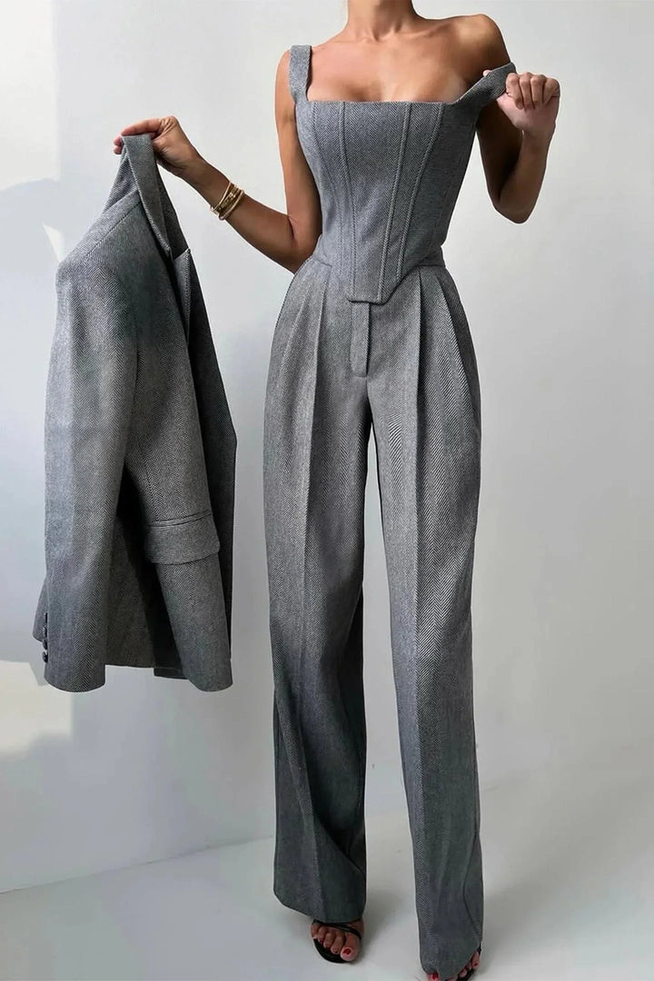 Sophisticated women's pink three-piece outfit including a structured corset, flowing wide-leg pants & a relaxed blazer.