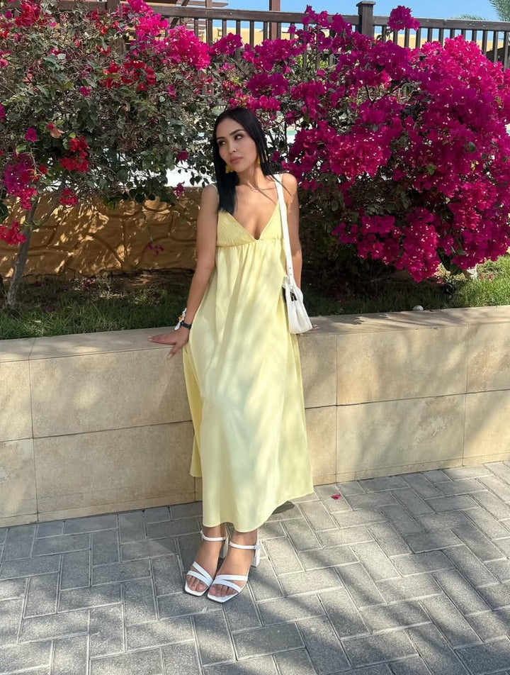 Chic sleeveless flowy maxi dress for women, featuring a flattering V-neck and backless design, ideal for summer.