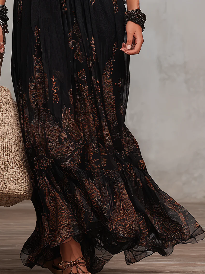 Flowing black elegant boho maxi dress with beautiful lace accents and flutter sleeves, versatile for summer or evening.