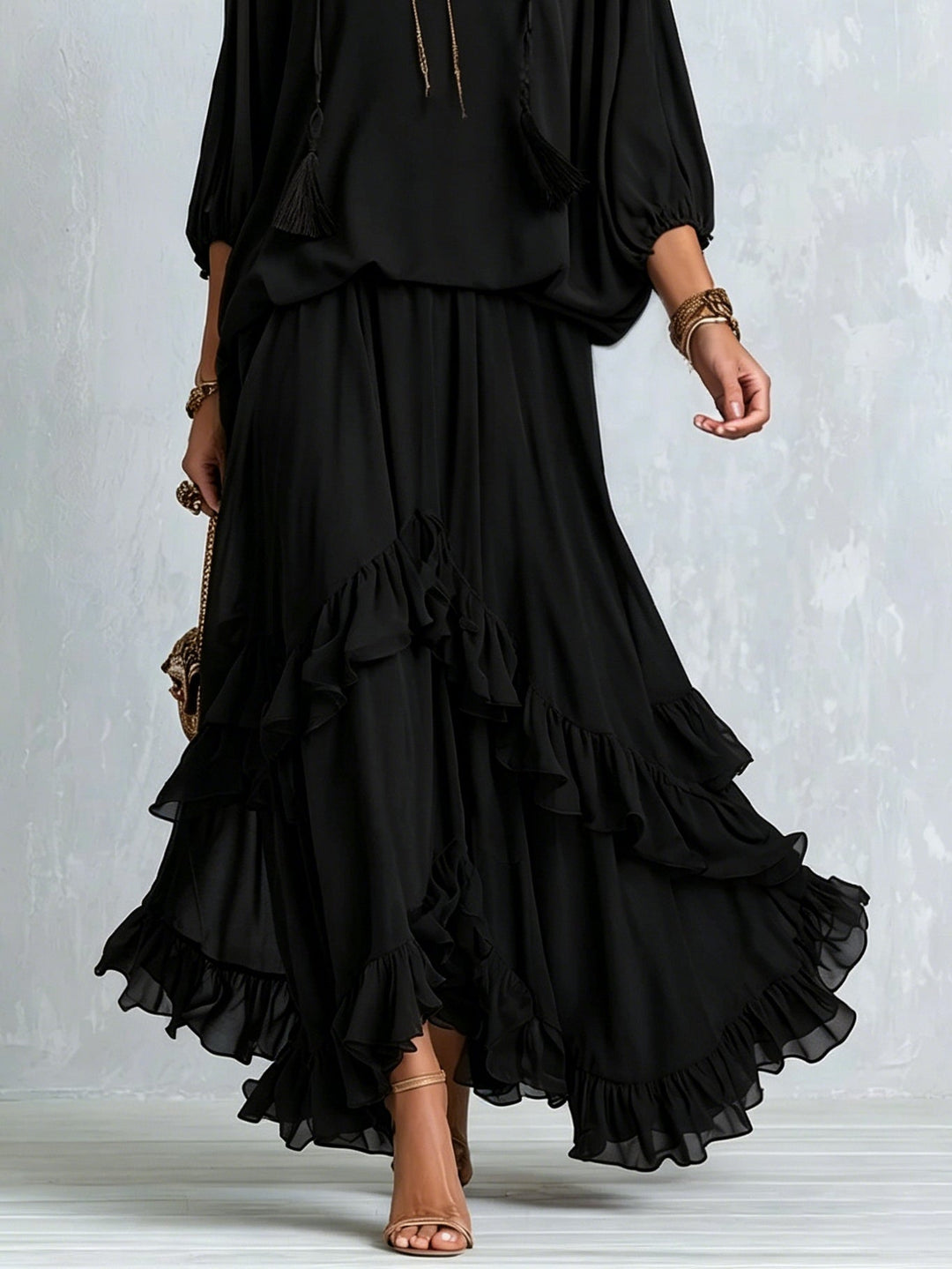 Women's stylish black boho maxi skirt set, featuring a relaxed V-neck top and a tiered ruffled skirt for elegant comfort.