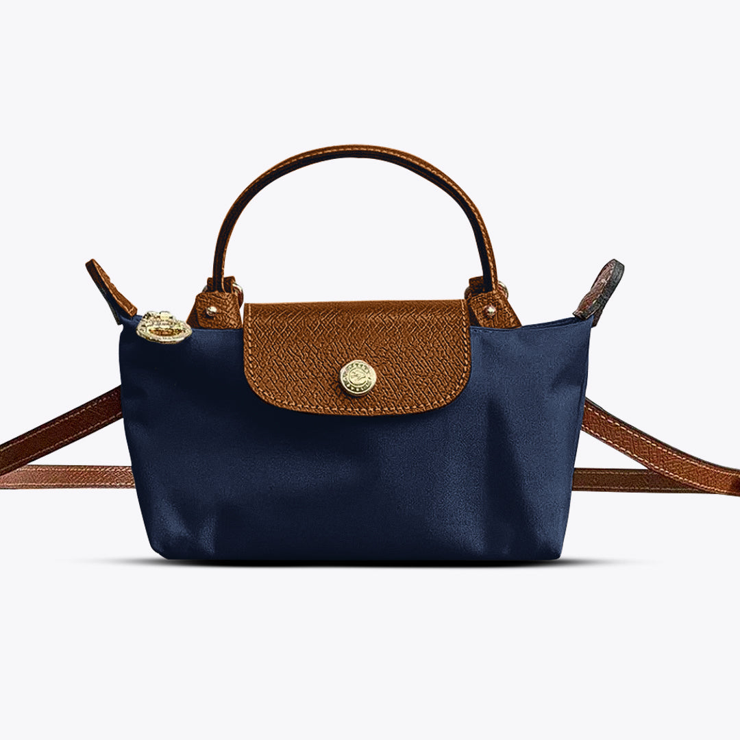Compact women's mini leather crossbody handbag with an adjustable strap, ideal for daily use & essential items.