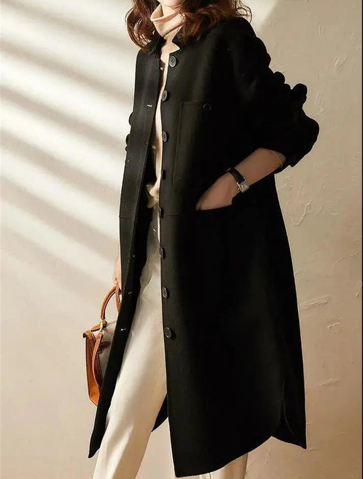 Elegant women's black long trench coat, versatile for casual or formal fall/winter outfits.