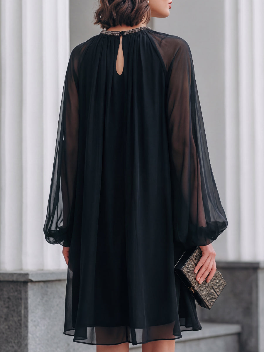 Sophisticated black mini dress, perfect for evening wear & special occasions. Features flattering fit & balloon sleeves.