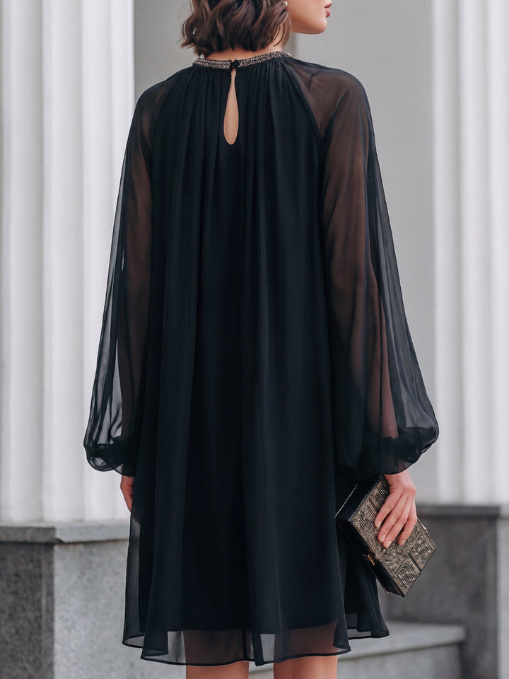 Sophisticated black mini dress, perfect for evening wear & special occasions. Features flattering fit & balloon sleeves.