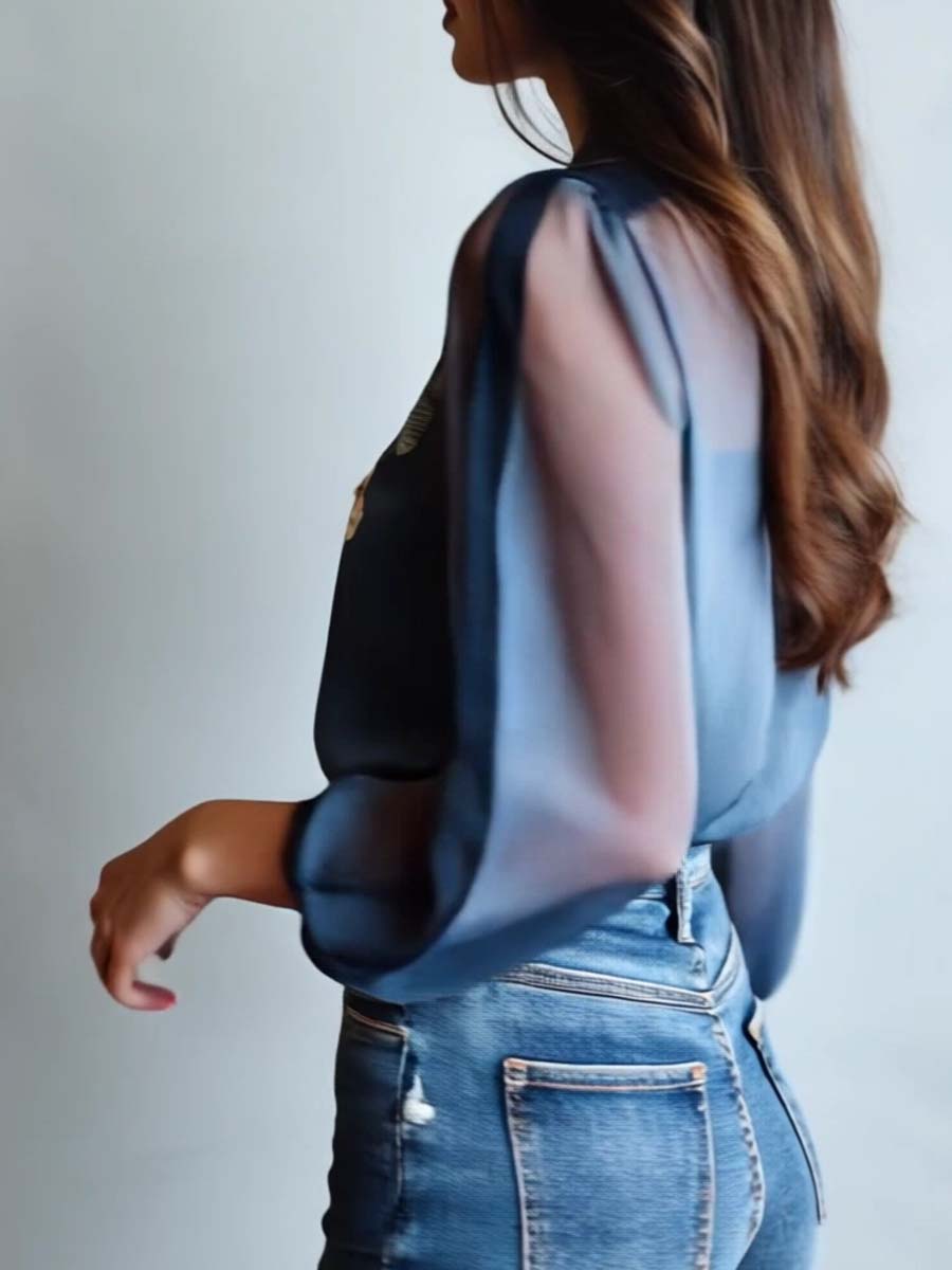 Feminine women's blouse featuring delicate floral embroidery & sheer long sleeves. A relaxed fit V-neck top.