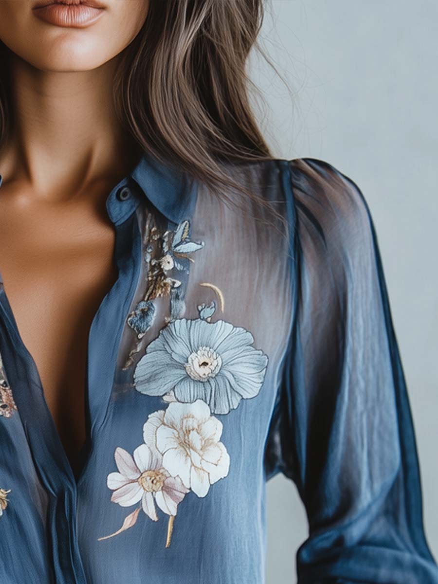 Modern elegant women's blouse. Features intricate floral embroidery, sheer sleeves & comfortable relaxed fit V-neck.