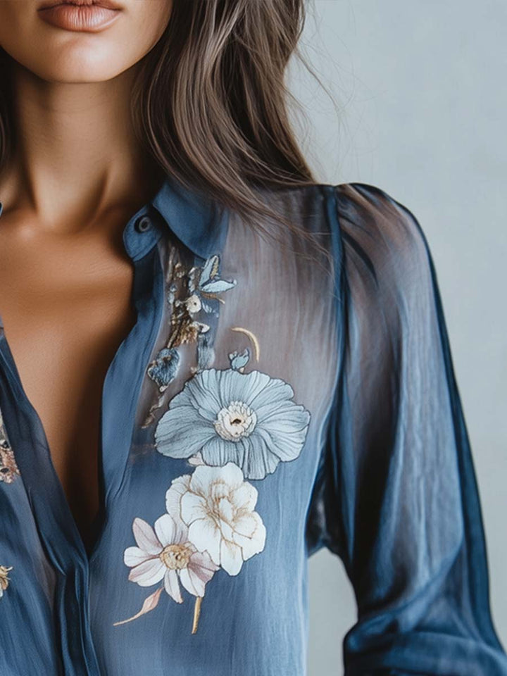 Modern elegant women's blouse. Features intricate floral embroidery, sheer sleeves & comfortable relaxed fit V-neck.
