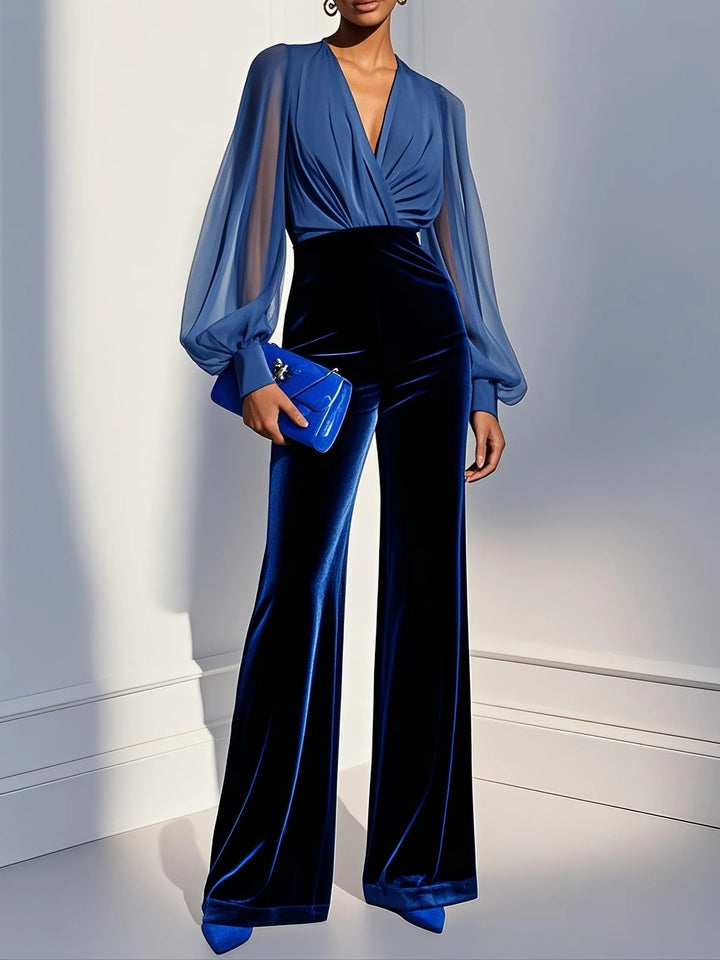 Elegant women's blue jumpsuit featuring a stylish mesh V-neck and long sleeves, perfect for evening or special occasions.