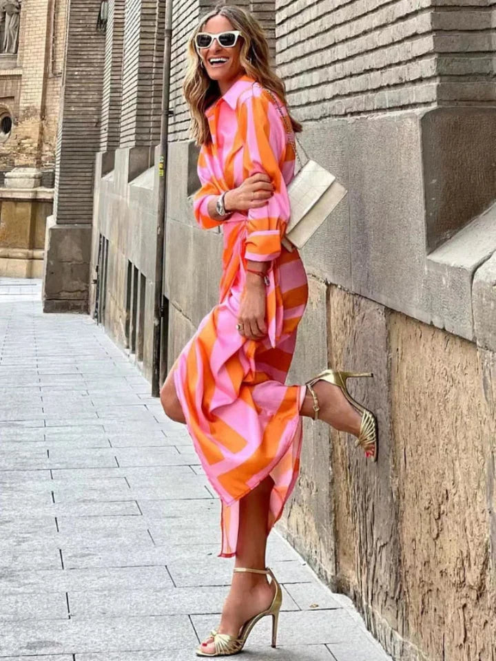 Flattering orange wrap front midi dress with V-neck & 3/4 sleeves. Ideal for elegant spring/summer fashion.