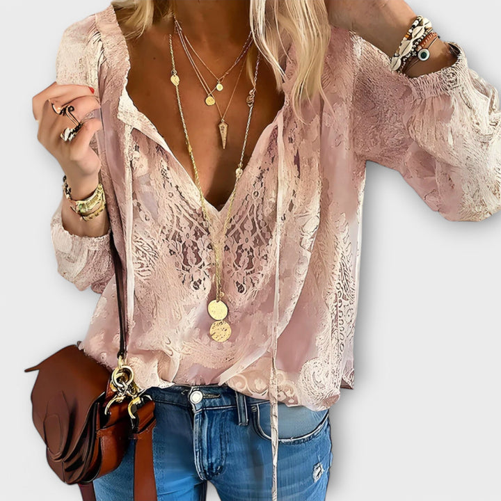 Women's elegant bohemian blouse with tie neck, a versatile long-sleeve top ideal for casual chic spring looks.
