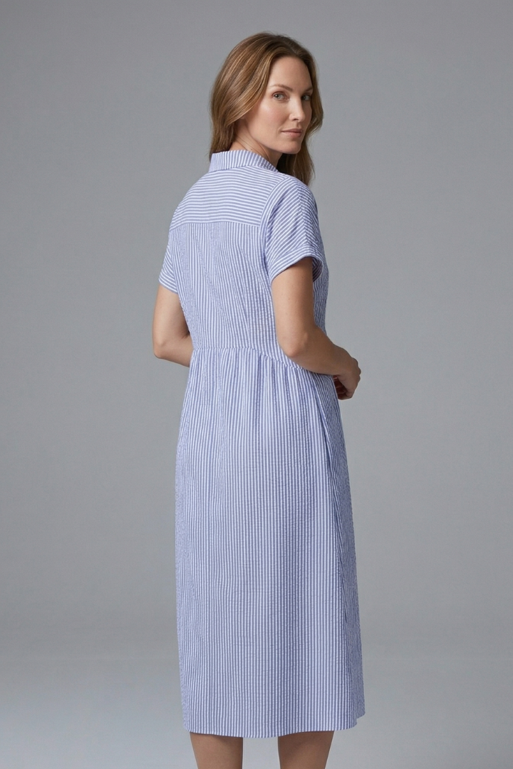 Close-up of the elegant collar and button-front on a women's stylish midi dress.
