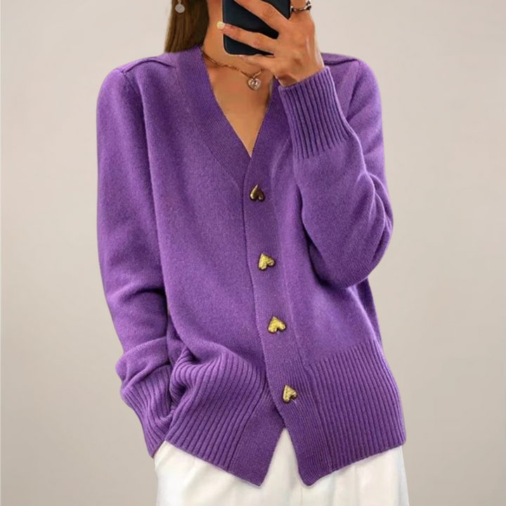 Stylish women's knit cardigan featuring long sleeves and unique gold heart buttons.
