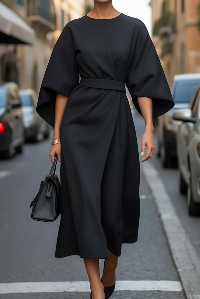 Close-up of luxurious fabric on a chic women's cocktail midi dress, great for evening wear.