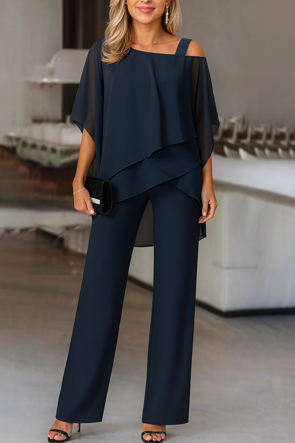 Women's modern cold-shoulder two-piece pants set, featuring a stylish top and flowing wide-leg trousers.