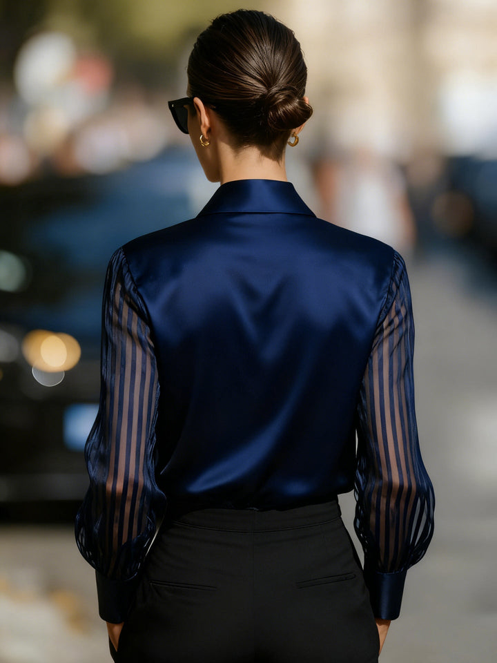 Modern women's work blouse, long sleeve button-up collared shirt with fashionable sheer stripe details.