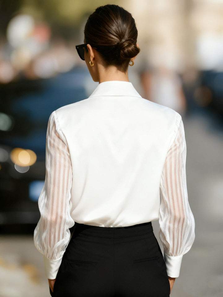 Side view of women's dressy collared blouse, featuring chic sheer stripe long sleeves and a tailored fit.