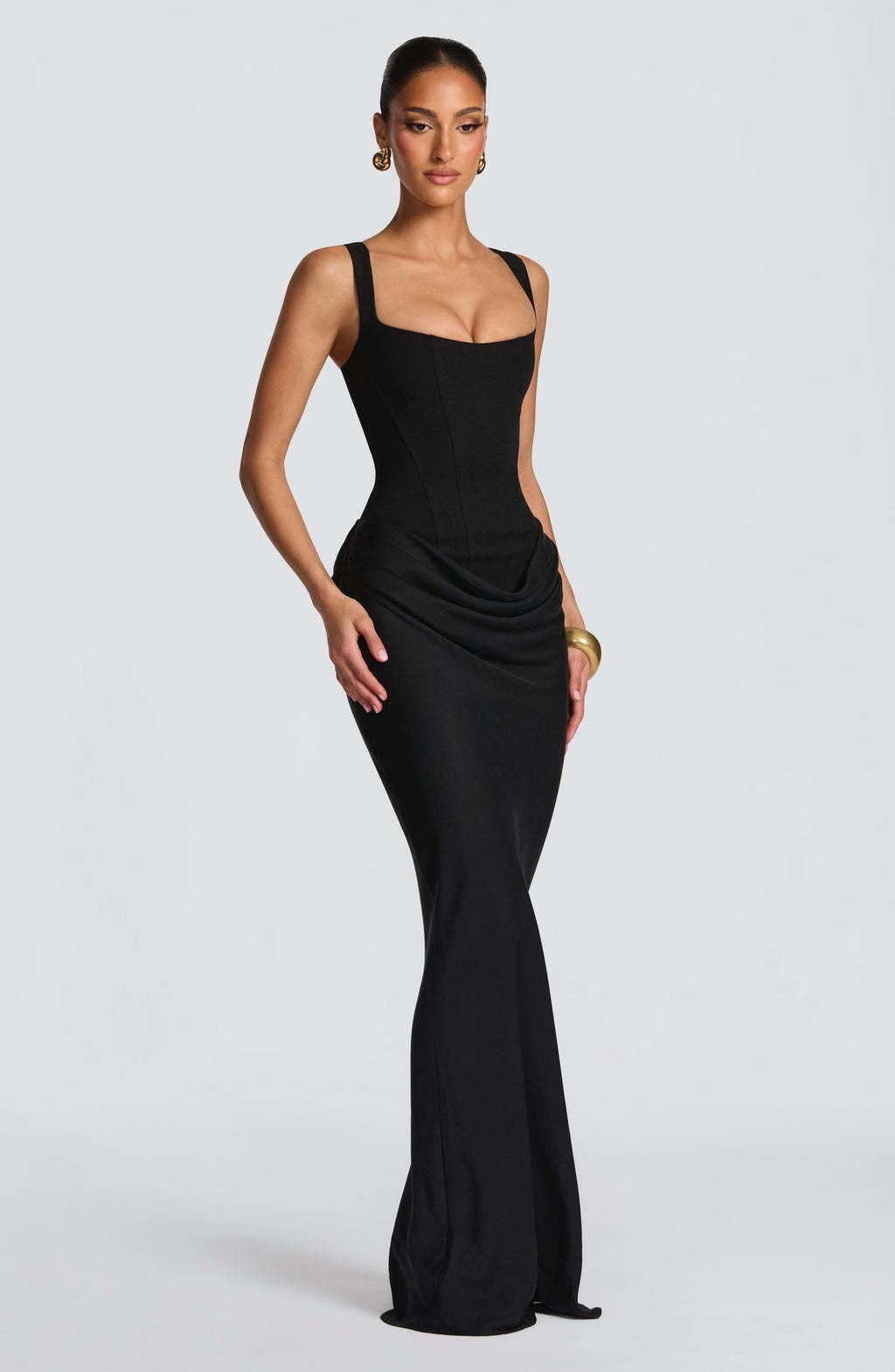 Women's long elegant dress. Solid color, sleeveless, with a structured corset bodice and wide strap detail.
