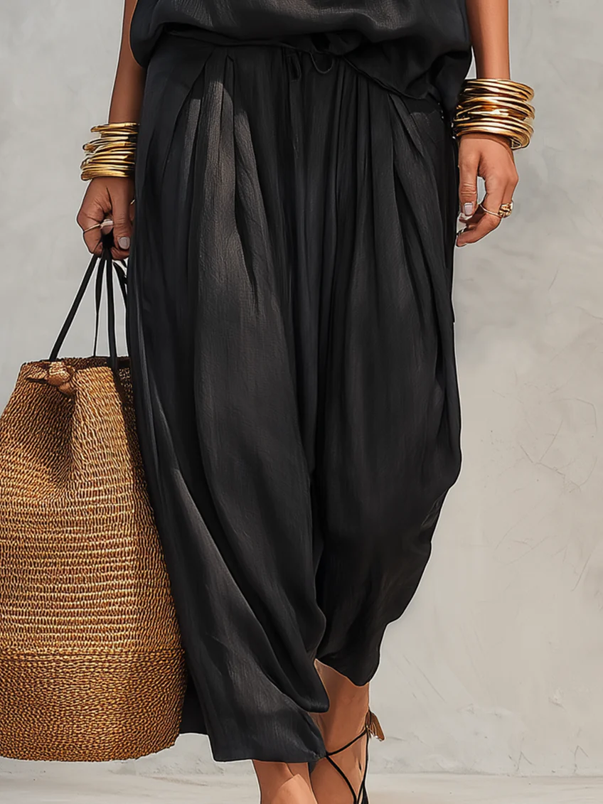Women's summer two-piece outfit featuring a cowl neck halter top and wide leg pants. Perfect vacation wear.