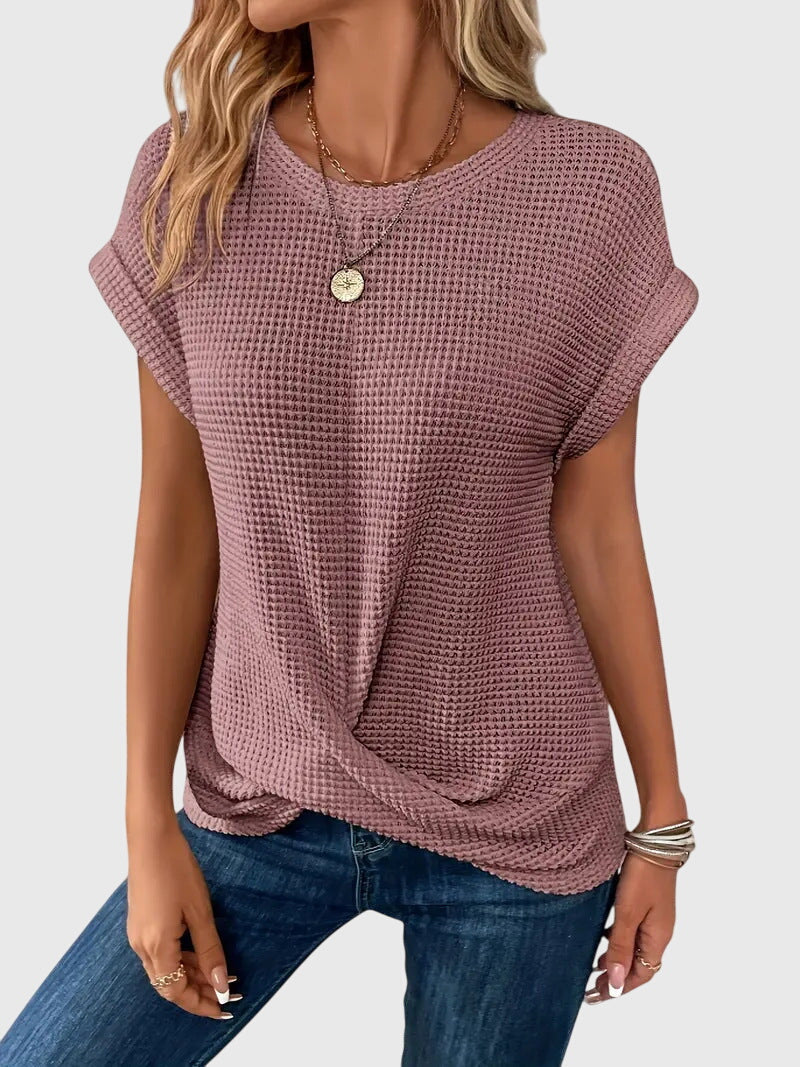 Chic women's blouse with a classic crew neck, ideal for stylish workwear or casual spring outfits.