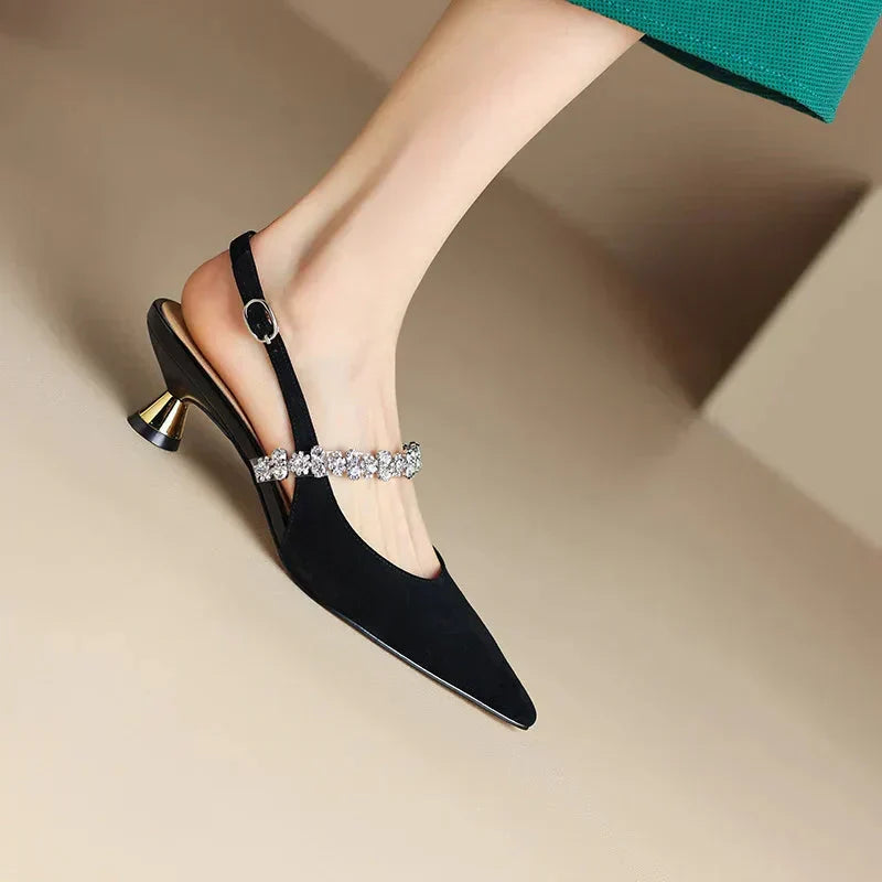 Sophisticated women's pumps with a crystal embellished slingback strap and pointed toe for special occasions.
