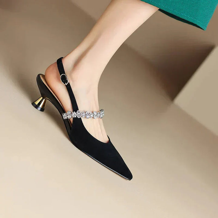 Sophisticated women's pumps with a crystal embellished slingback strap and pointed toe for special occasions.