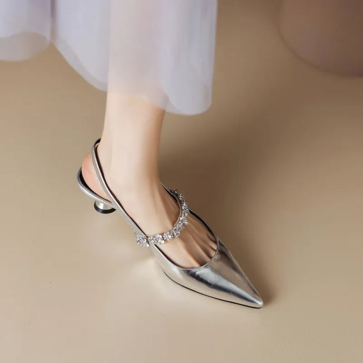 Glamorous women's pointed toe heels with shimmering crystal ankle strap, ideal for formal events & weddings.