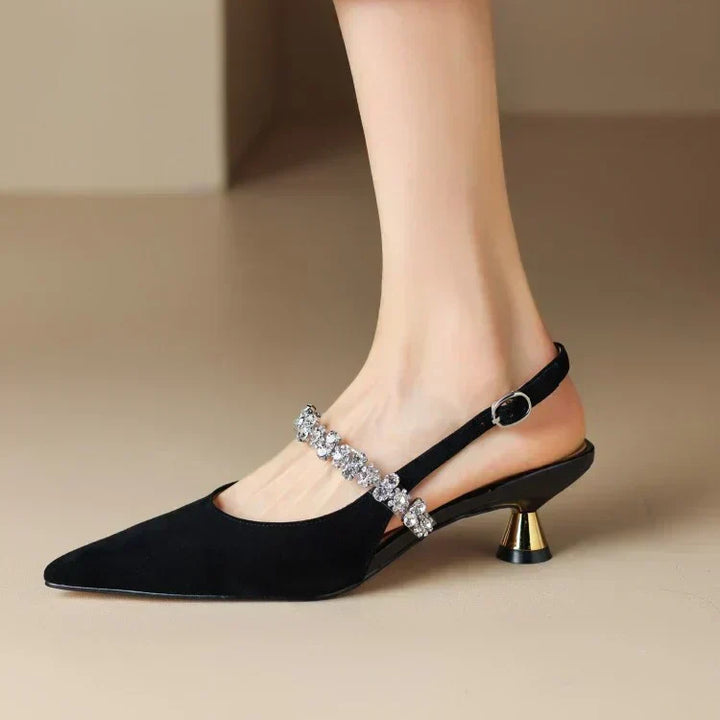 Detailed shot of women's fashion heels showcasing a sparkling crystal strap and elegant pointed toe silhouette.