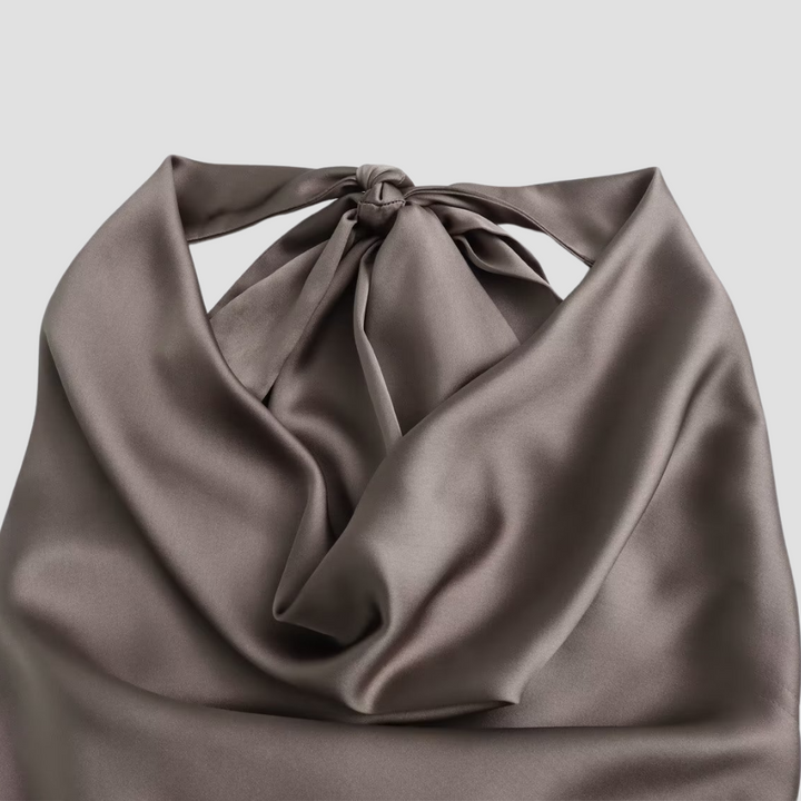 Stylish women's summer halter top, sleeveless and elegantly draped, perfect for warm weather fashion.