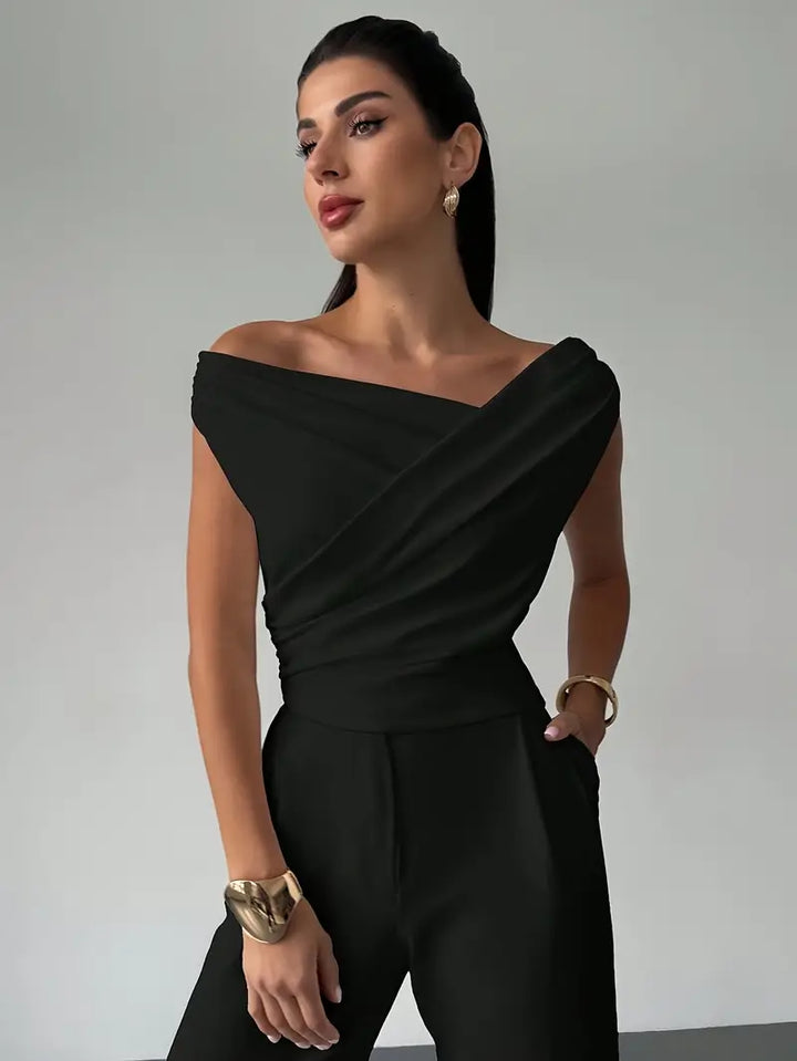 Stylish black draped shoulder top for women, versatile for casual chic or dinner outfits.