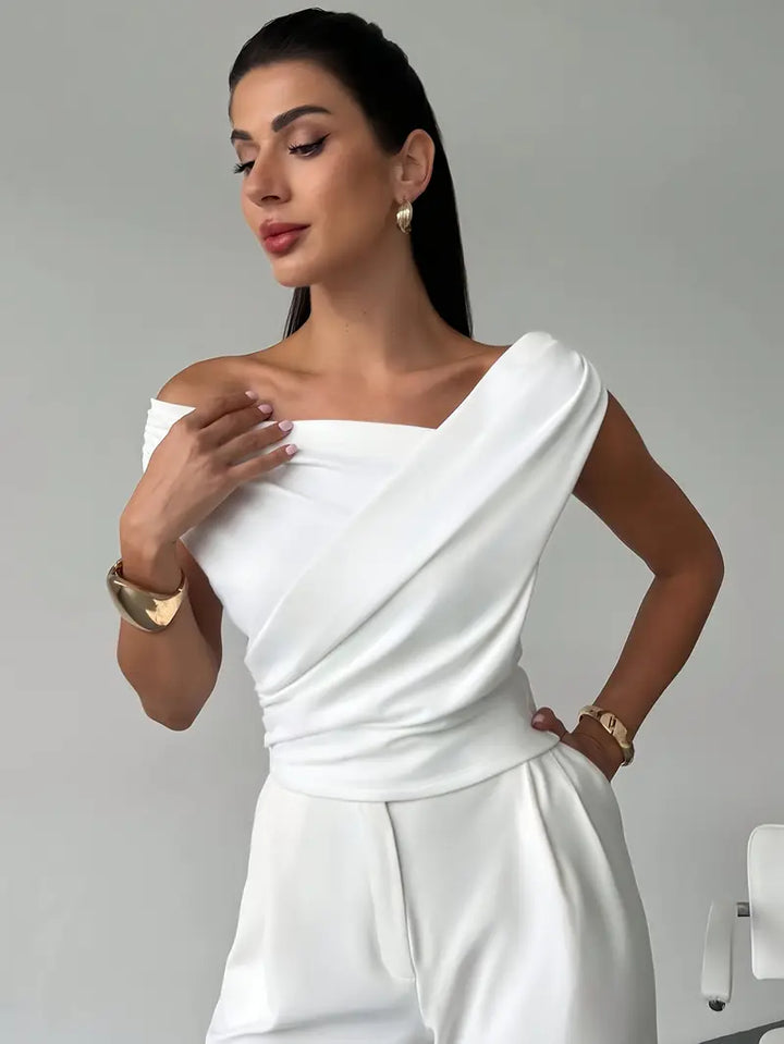 Chic white draped shoulder top, an elegant blouse perfect for evening events and gatherings.