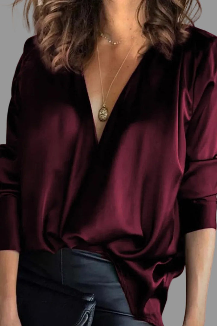 Chic women's draped V-neck blouse, relaxed fit. Versatile elegant top for evening or sophisticated day wear.