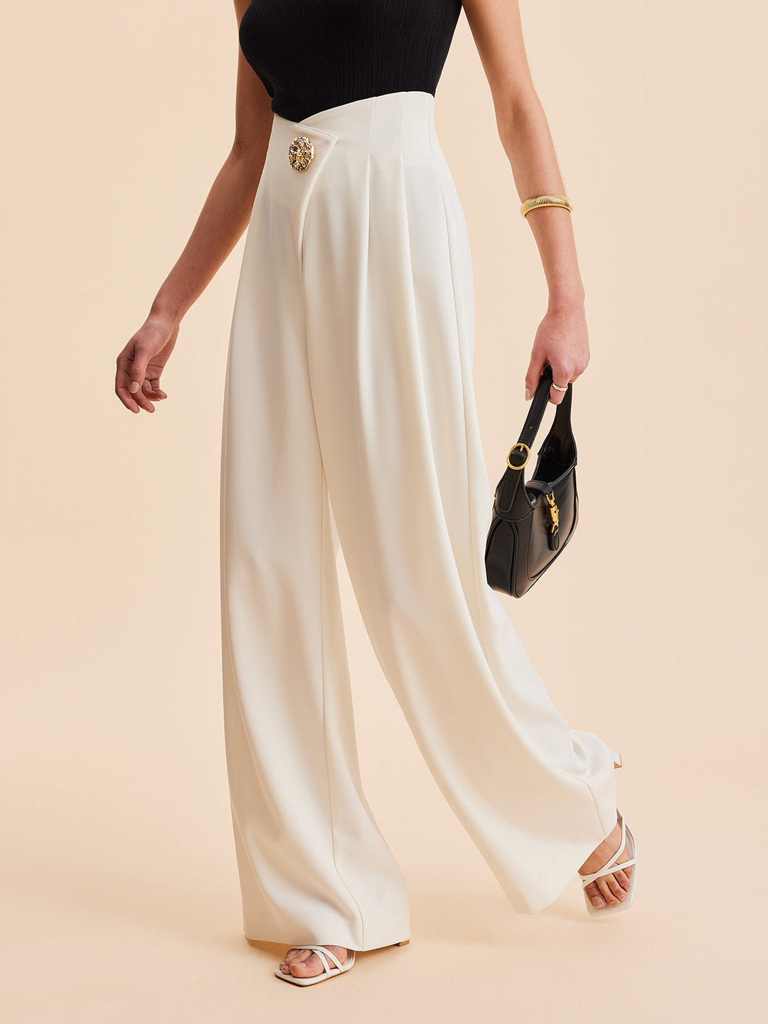 Black embellished high-waist wide-leg women's pants. Asymmetrical design for a sophisticated & modern look.