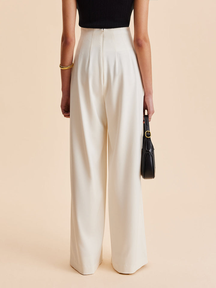 Asymmetrical embellished wide-leg high-waist trousers for women. Elegant long pants for sophisticated casual chic.