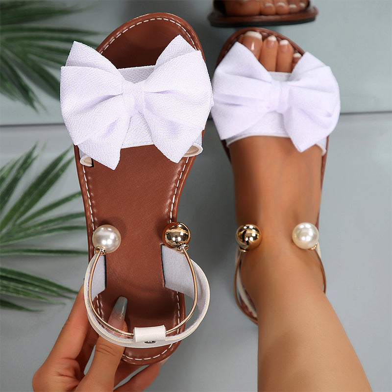 Beaded women's flat sandals featuring a chic bow, offering elegant comfort for summer daily wear.