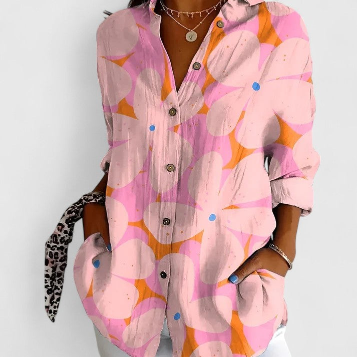 Vibrant floral print blouse for women. Elegant chic top suitable for casual or office wear. Summer fashion.