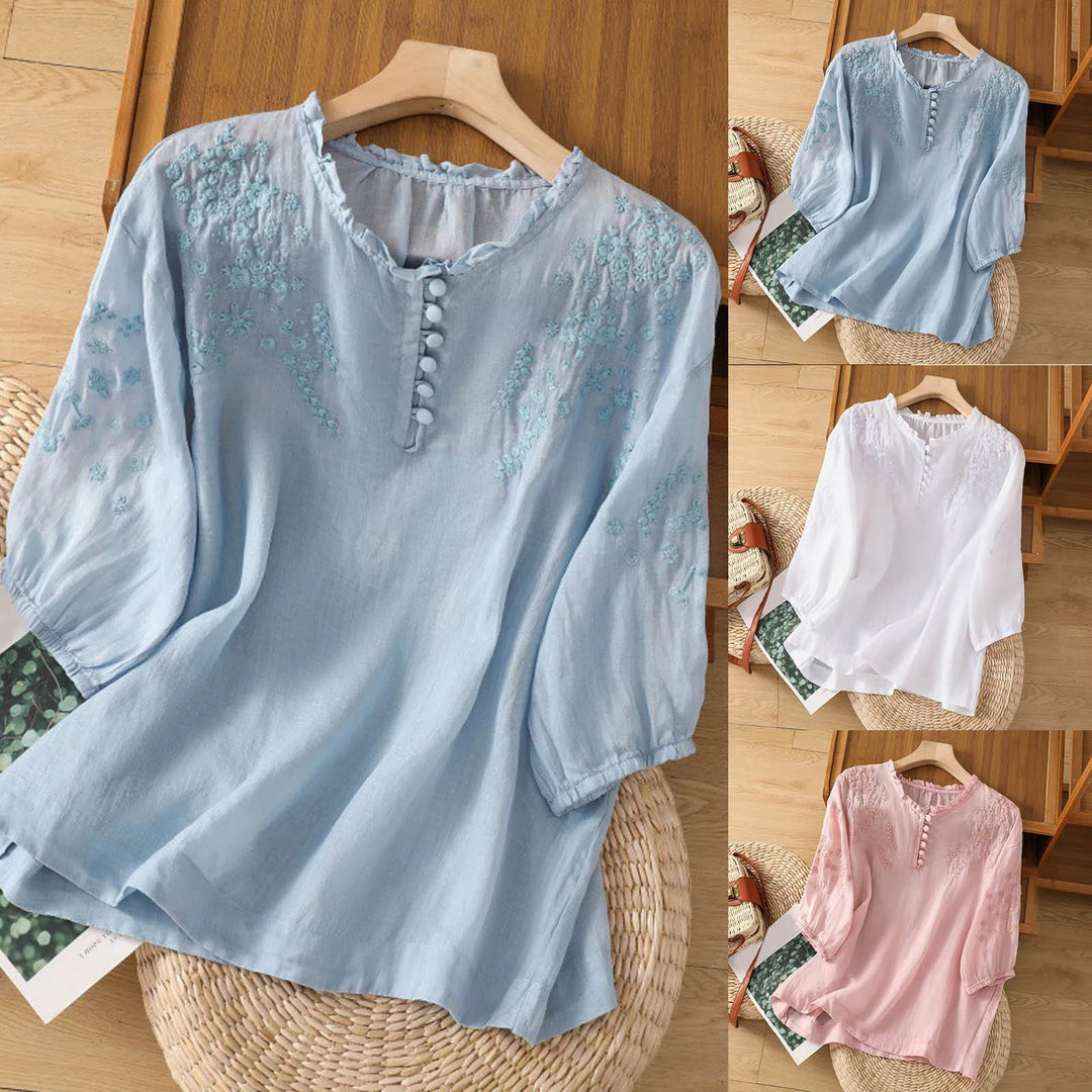 Detailed embroidered floral women's blouse, a sophisticated button-front top for elegant spring & summer fashion.