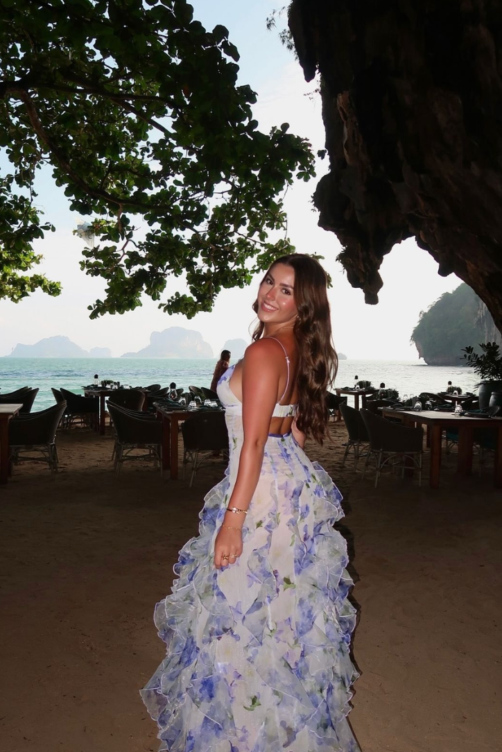 Flowing women's floral ruffle maxi dress with a delicate corset bodice, creating an elegant wedding guest look.