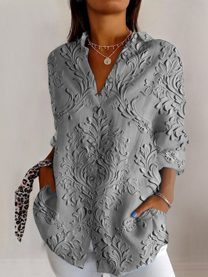 Modern women's floral embossed long sleeve V-neck blouse. A dressy yet casual chic top for any stylish woman.