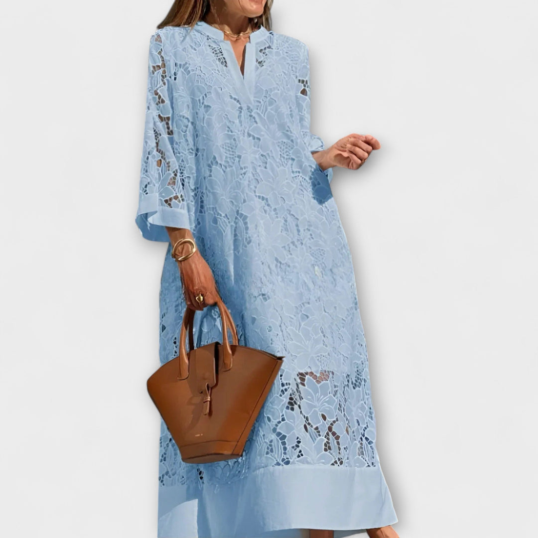 Women's elegant midi dress, intricately embroidered with floral patterns, featuring a flattering fit for evening wear.