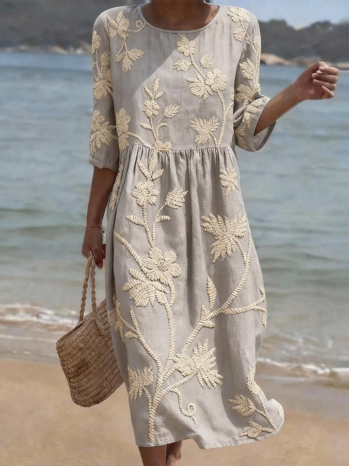 Women's round neck midi dress with exquisite floral embroidery and comfortable three-quarter sleeves.