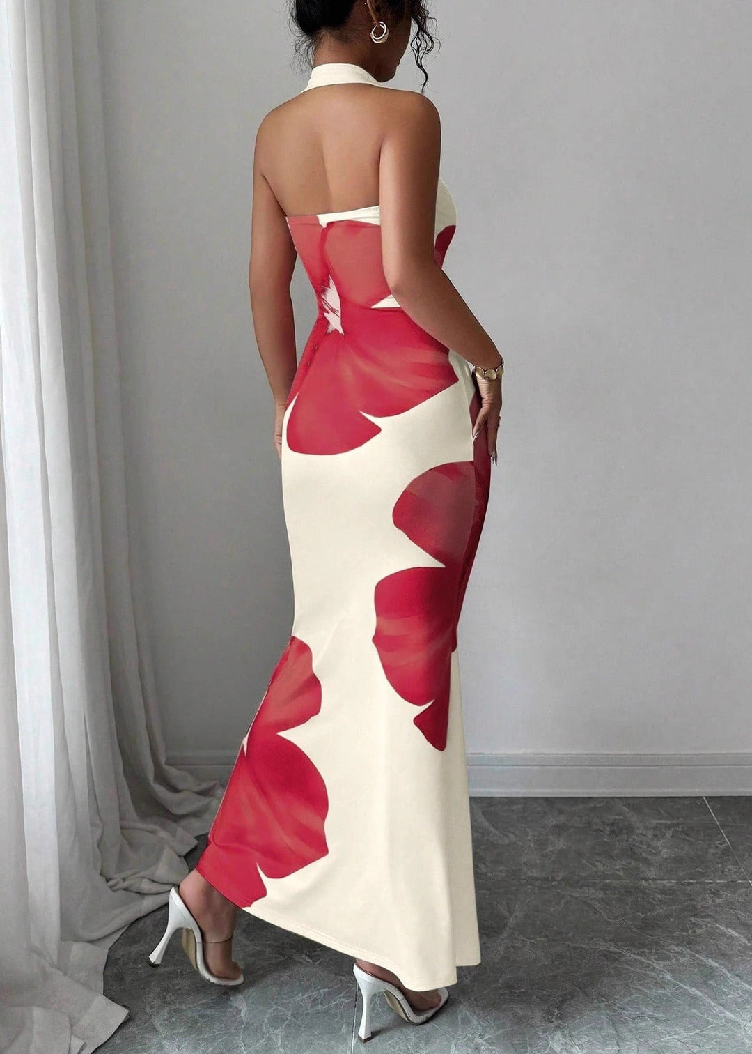Chic women's halter neck maxi dress, adorned with a graceful floral pattern, perfect for summer elegance & resort fashion.